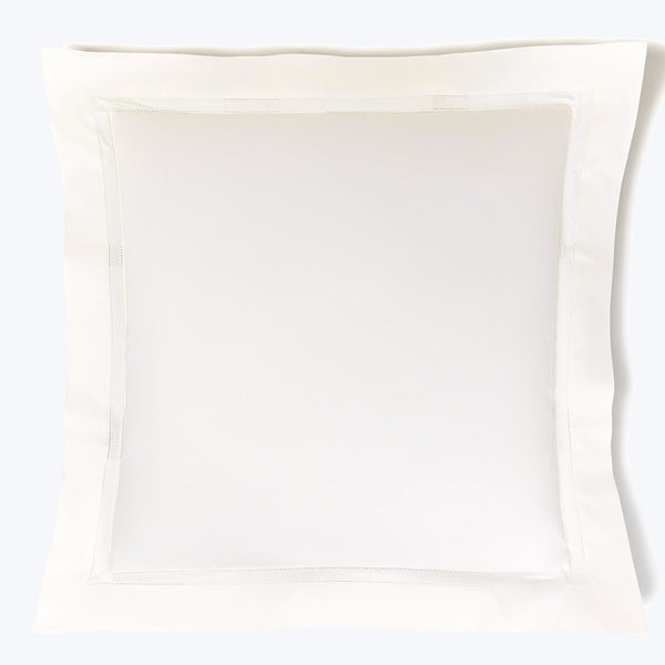 White pillowcase with elegant border stitching on smooth cotton fabric.