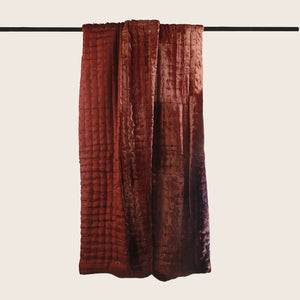 Folded orange velvet quilt with quilted design for ultimate comfort. - hover