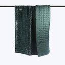 Two crinkled silk textiles in gradating shades hanging vertically.