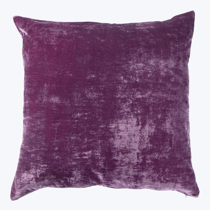 Square purple velvet pillow with plush texture and mottled pattern.