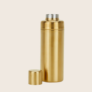 Metallic gold cocktail shaker with lid and strainer on white - hover