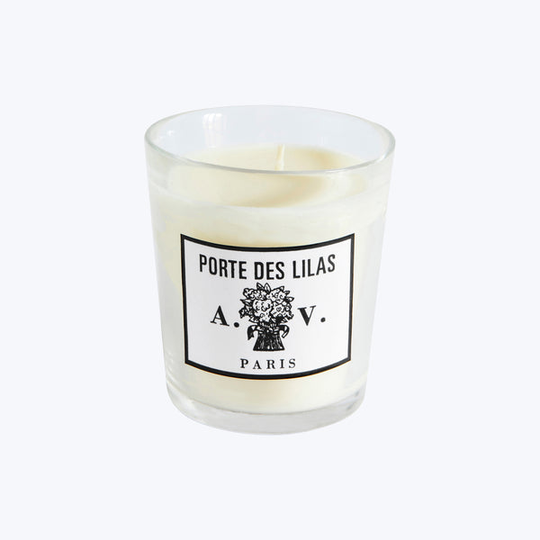 Elegant glass candle with Parisian-inspired label and floral design.