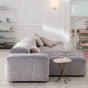 Contemporary and minimalist light gray sectional sofa with tufted cushions. - hover
