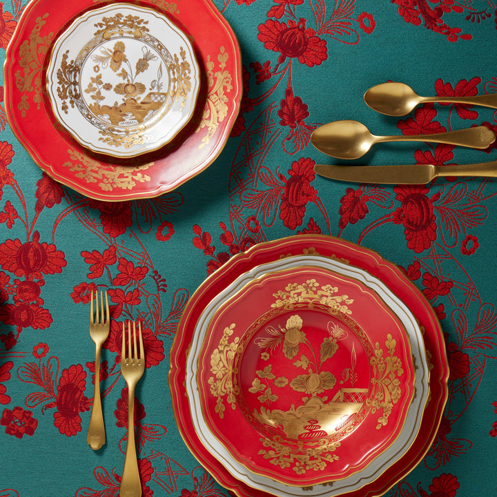Opulent and festive table setting with red and gold accents.