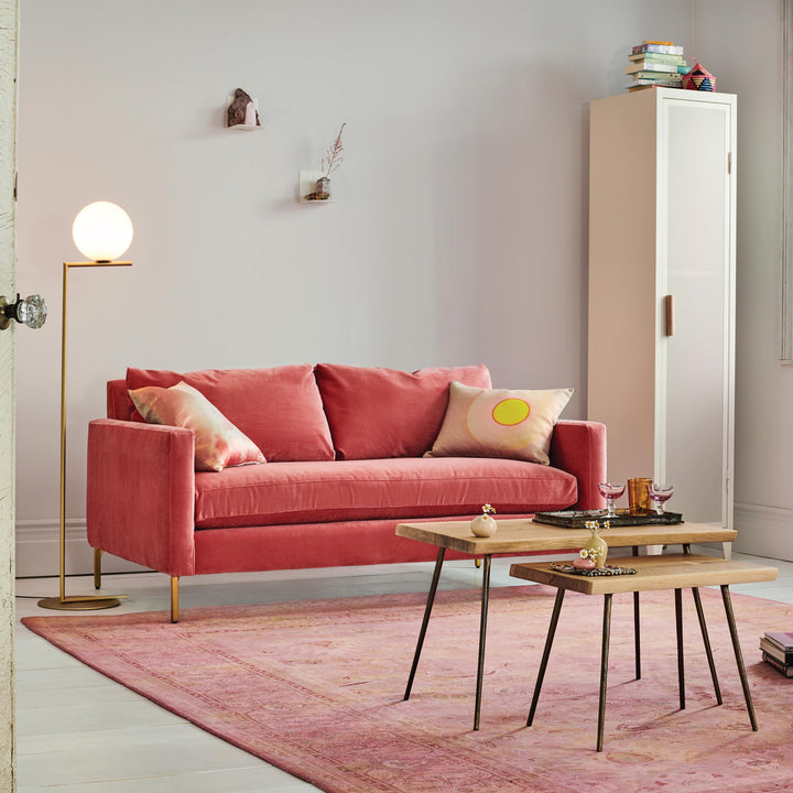 Modern living room with pink theme, stylish decor and cozy ambiance.