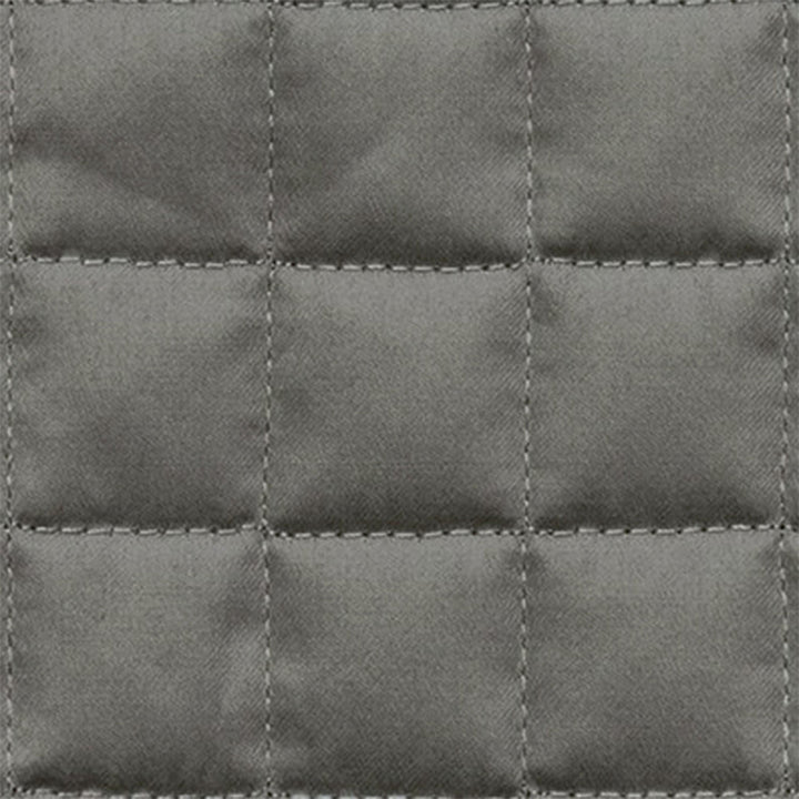 Close-up of gray quilted fabric with raised grid pattern stitching.