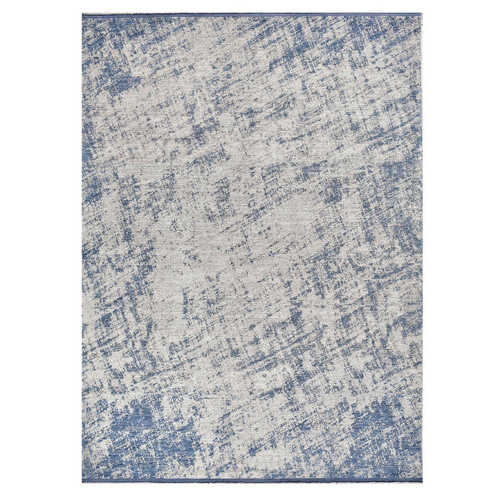 Rectangular distressed area rug with abstract blue and beige pattern.