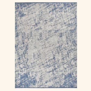 Rectangular distressed area rug with abstract blue and beige pattern.