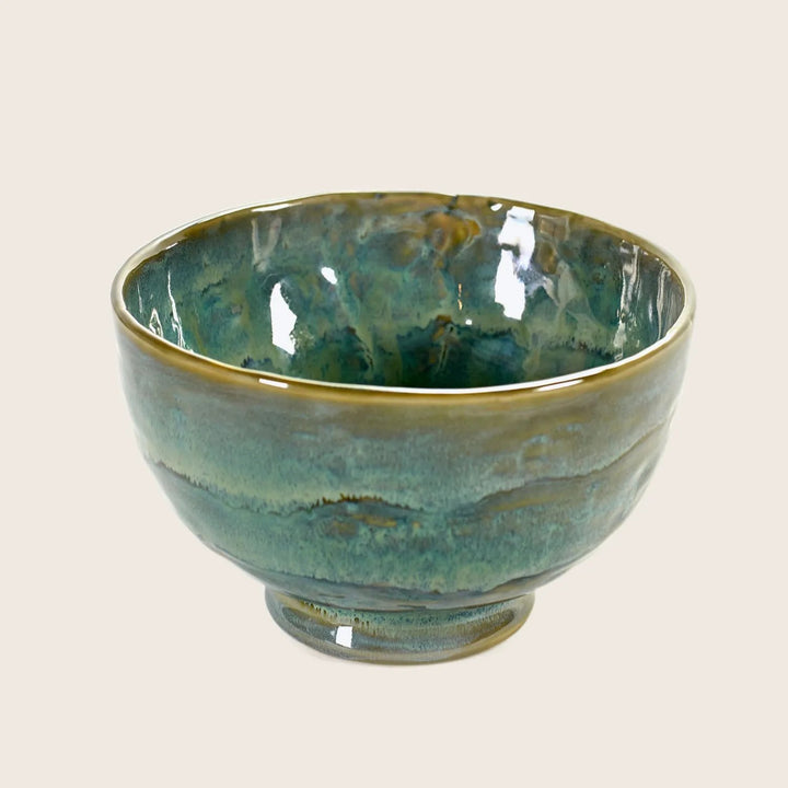Handmade ceramic bowl with green glaze and glossy finish.