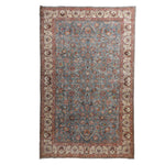 Traditional patterned rug with intricate floral motifs in muted colors.