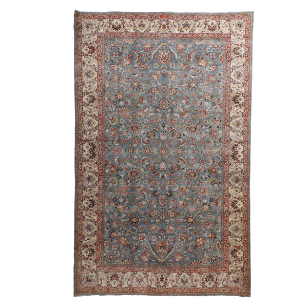 Traditional patterned rug with intricate floral motifs in muted colors.