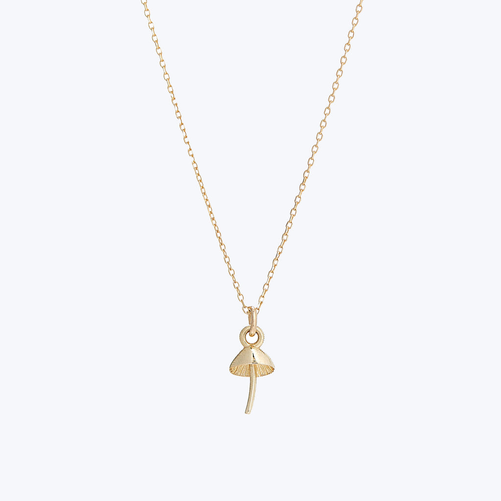 Gold Ankh necklace symbolizing life and immortality on white background.