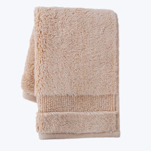 Plush terrycloth towel with decorative border, neatly folded for display. - hover