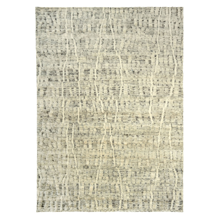 Rectangular rug with abstract pattern in muted cream and gray.