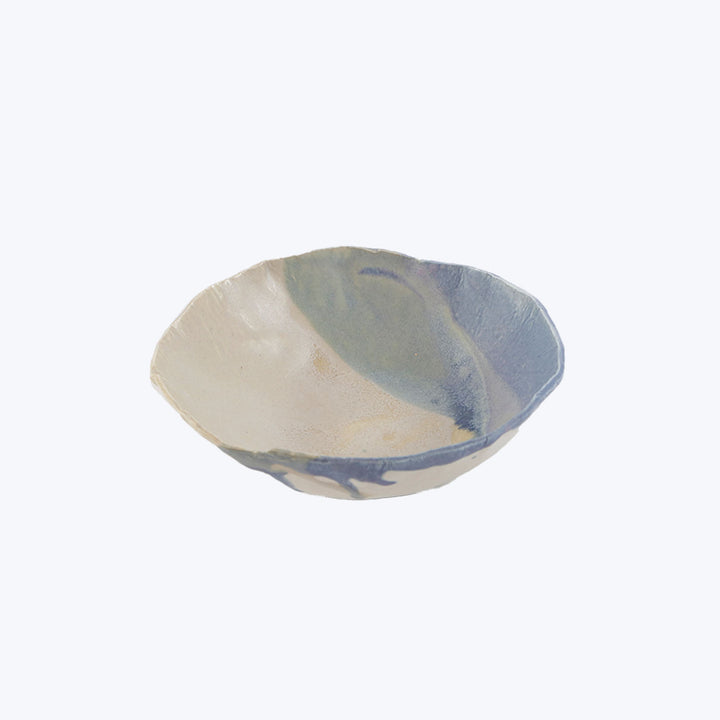 Handmade ceramic bowl with unique shape and colorful glaze finish.