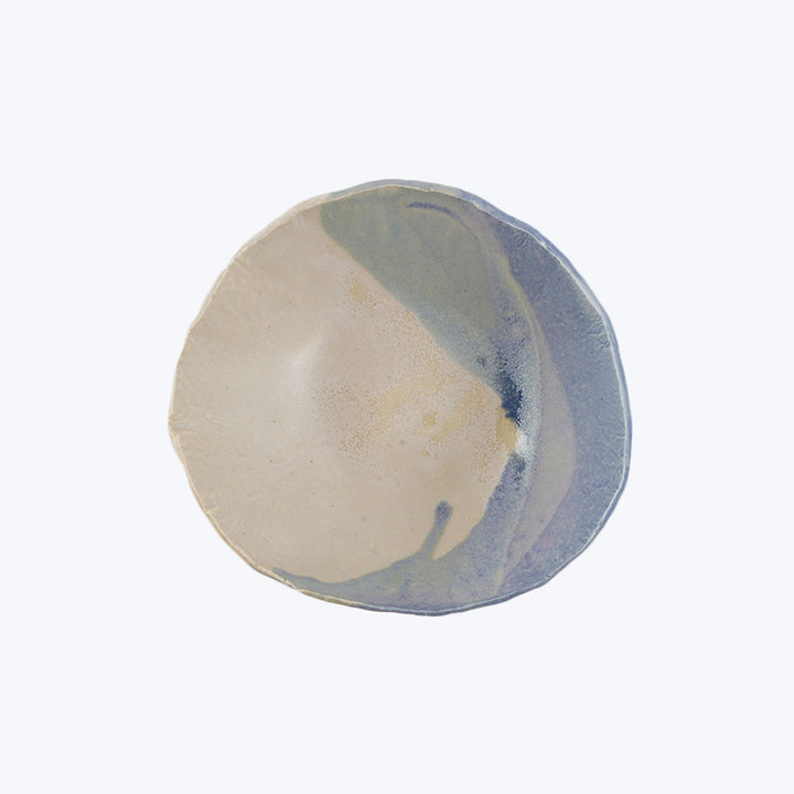 Handmade ceramic coaster with marbled beige, blue, and yellow colors.