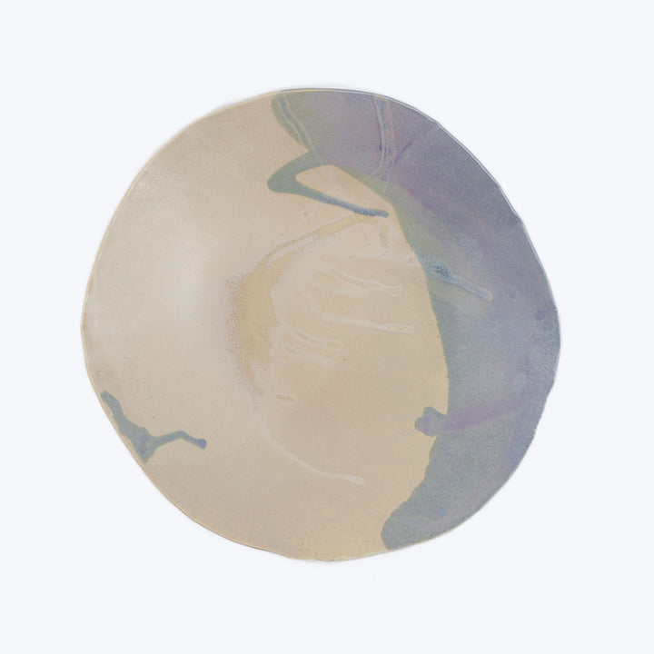Colorful glazed ceramic plate with watercolor effect on white background.