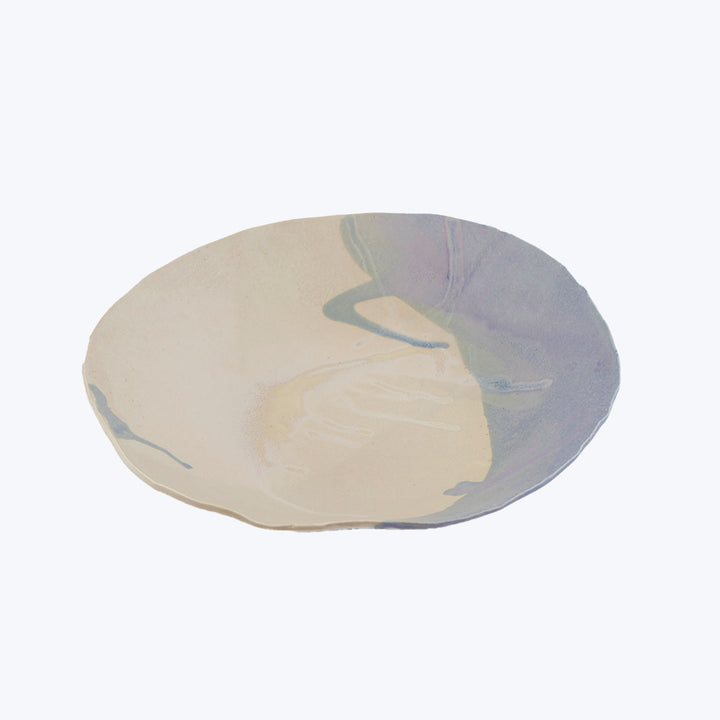 Minimalist modern ceramic dish with marbled pastel swirls, soft edges.