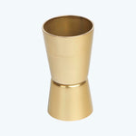 Gold-colored jigger for precise cocktail measurements, with sleek metallic finish.