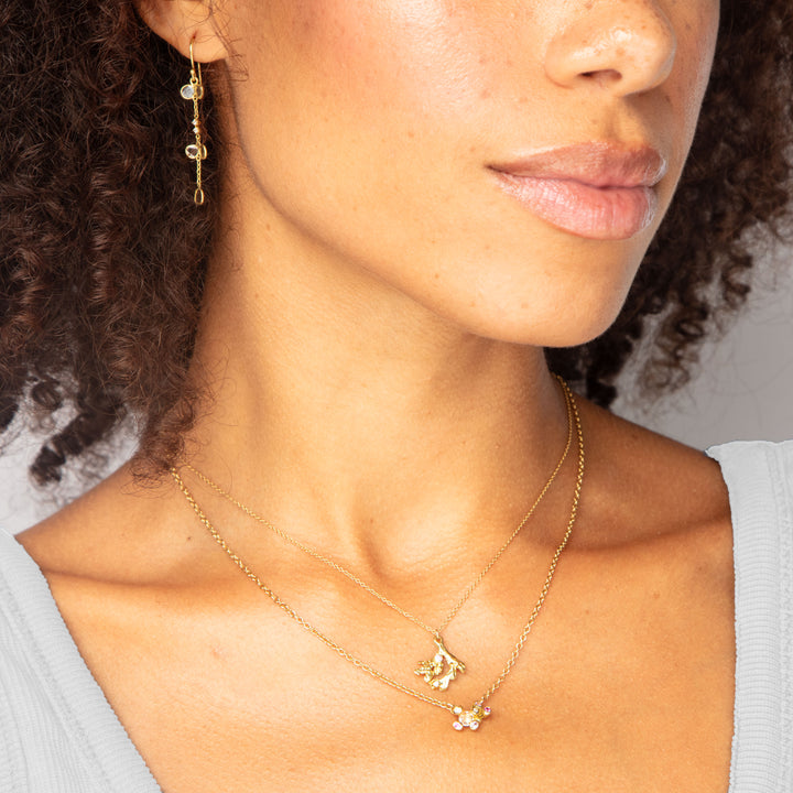 Close-up of woman's profile showcasing elegant jewelry on brown skin.