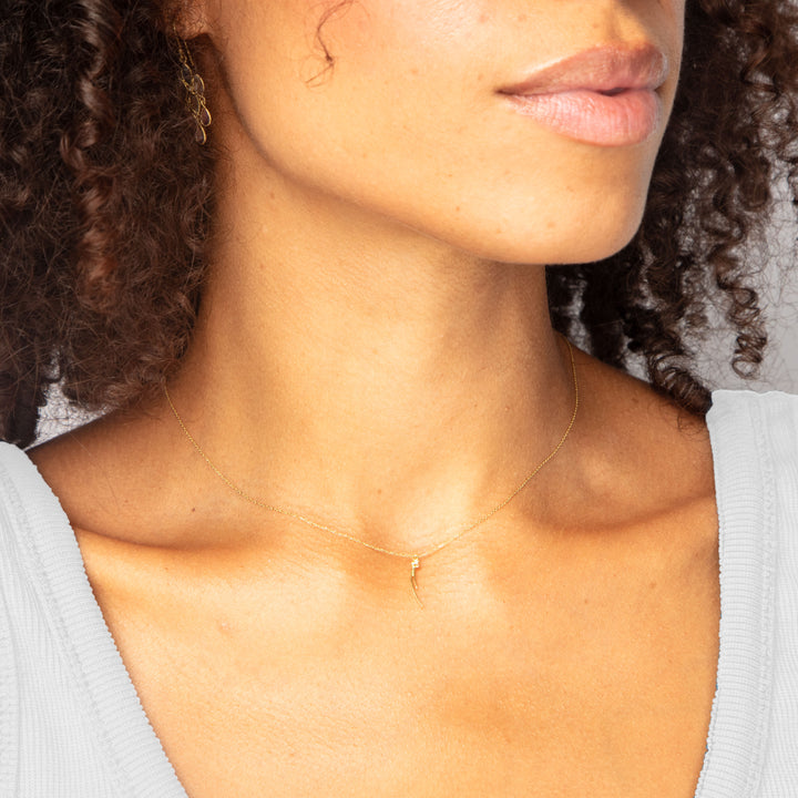 Close-up of person in elegant necklace with small pendant