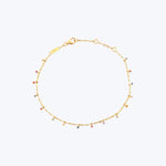 Gold bracelet with colorful gemstones on delicate chain, elegant design.