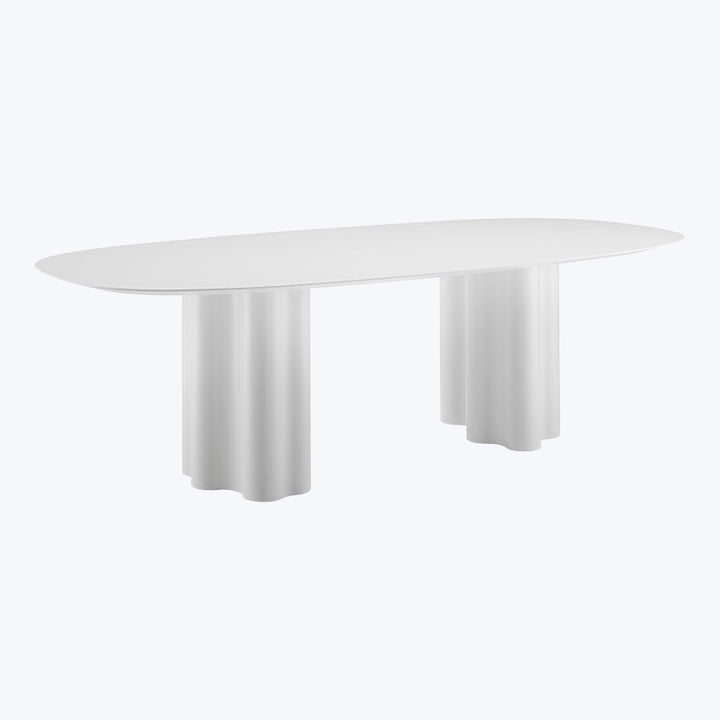 Contemporary oval table with white surface and minimalist design elements.
