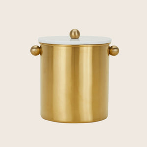 Gold-colored cylindrical container with lid and spherical handles on white
