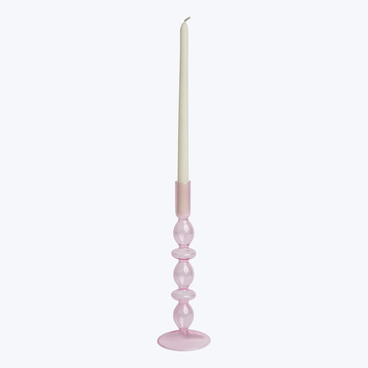 Single white taper candle in elegant pink holder, unused wick.