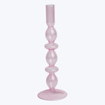 Translucent pink glass candlestick holder with bulb-like shapes, white background.