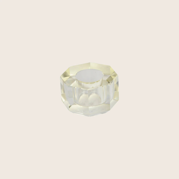 A transparent faceted glass ashtray with octagonal shape design.