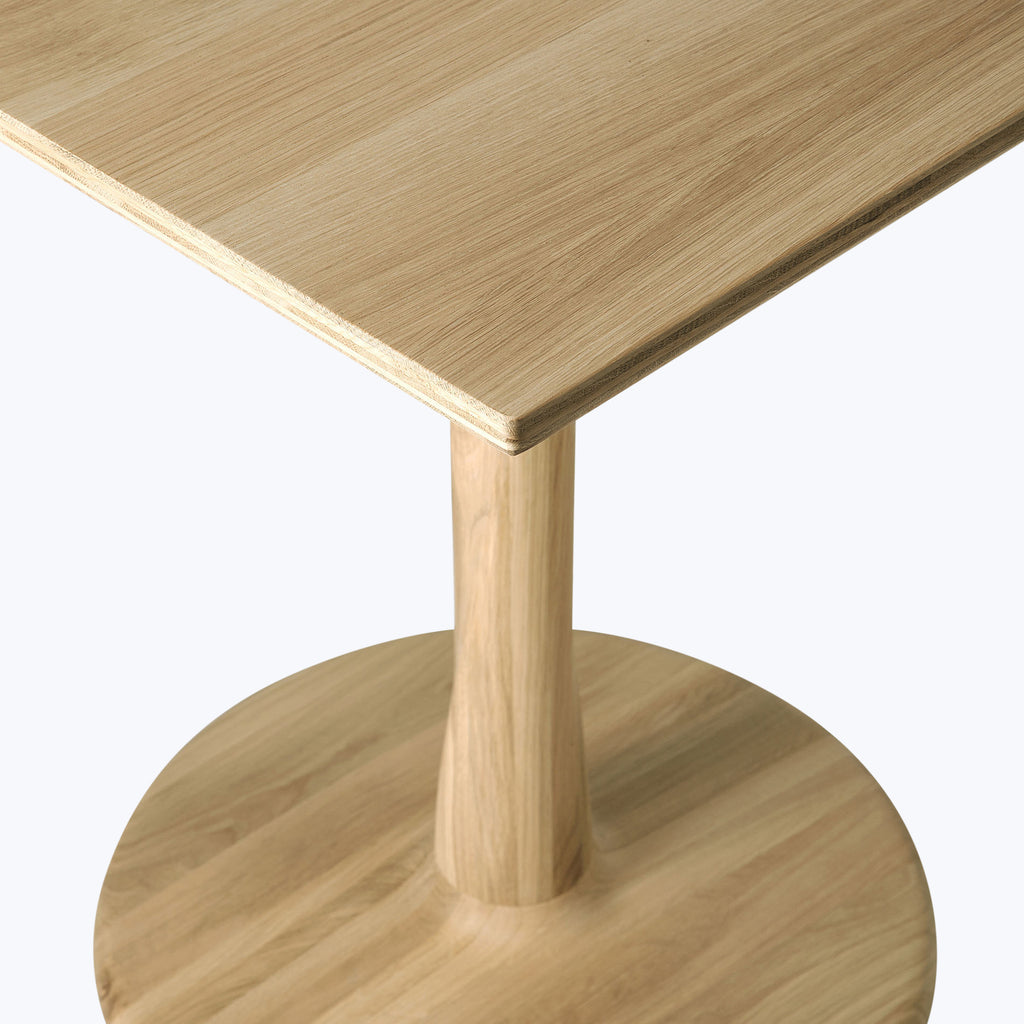 Minimalist light wood table with contemporary design and natural grain.