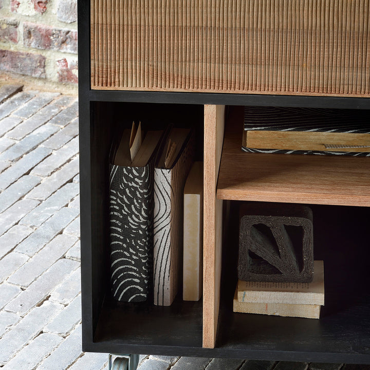 Close-up of modern wooden shelving with books and decor items