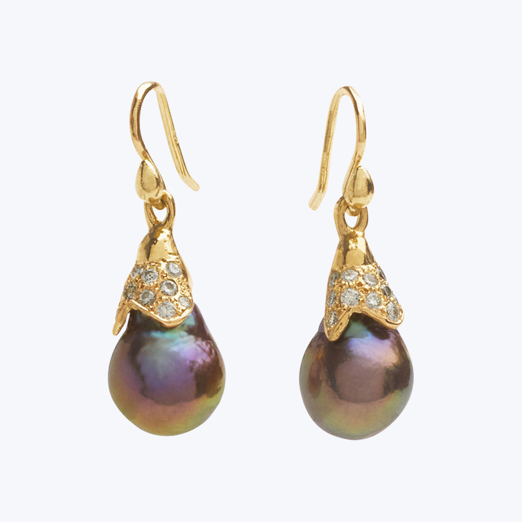 Elegant drop earrings with gold, diamonds, and iridescent pearls. Luxurious.