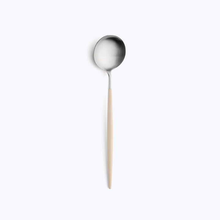 Single spoon with round bowl and tapered handle on white background.