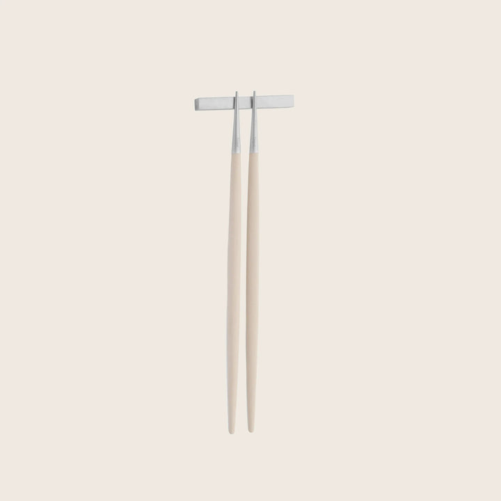Pair of metal tuning forks on wooden handles, white background.