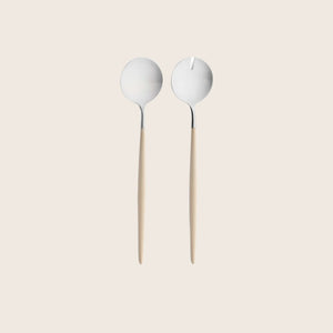 Stylish salad servers with unique bowl designs, wooden handles.