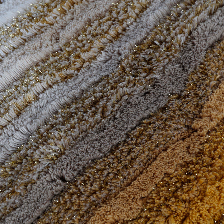 Close-up of plush, tufted fabric with striped pattern in shades.