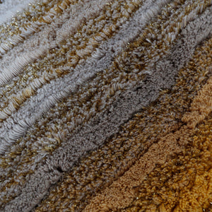 Gradient of color tones in shaggy rugs from grayscale to warm. - hover