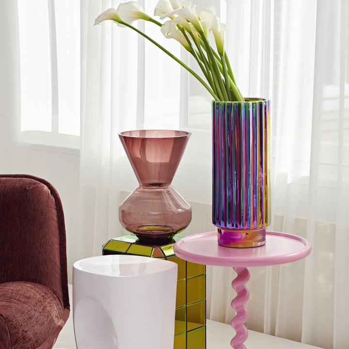 Bright, airy interior with modern decor, colorful accents, and flowers.