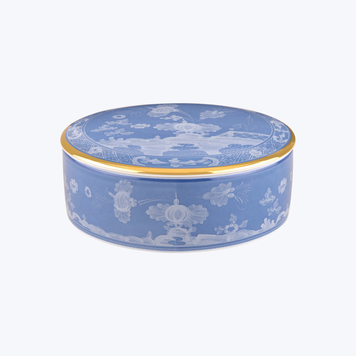 Vintage oval tin box with blue and white floral design.