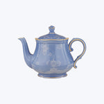 Blue ceramic teapot with floral patterns and glossy finish.