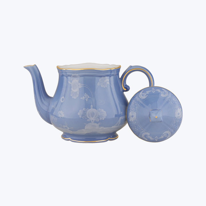 Blue ceramic teapot with floral design and gold trim detail.