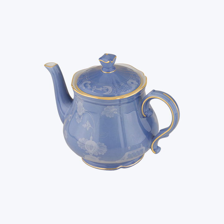 Blue ceramic teapot with white floral motifs and gold accents.