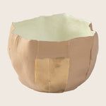 Kintsugi repaired ceramic bowl with visible golden seam, showcasing history