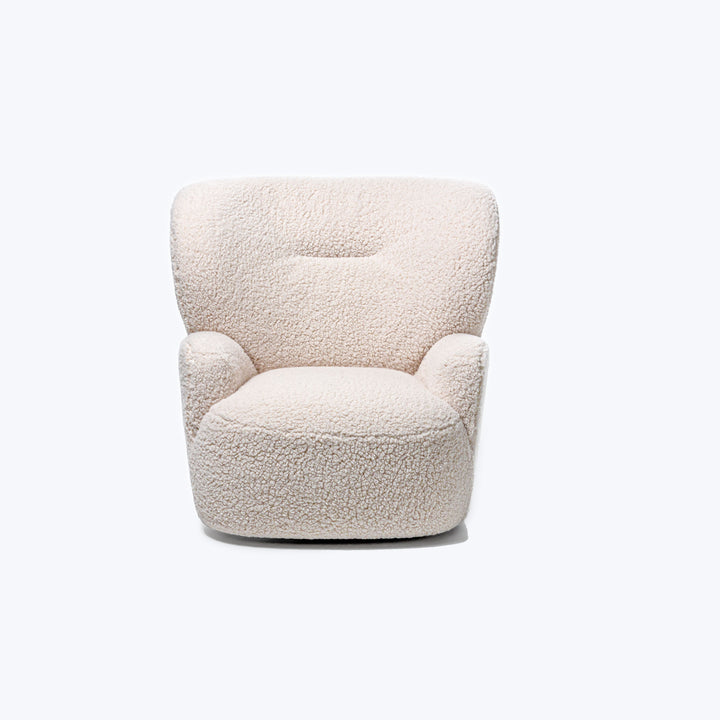 Modern armchair with sheepskin-like upholstery, minimalist design against white background.