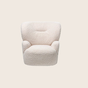 Modern armchair with sheepskin-like upholstery, minimalist design against white background.