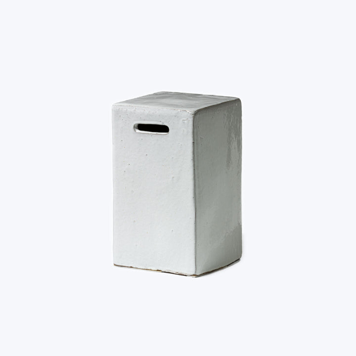 Simplistic greyish-white box with slit, possibly a suggestion box.