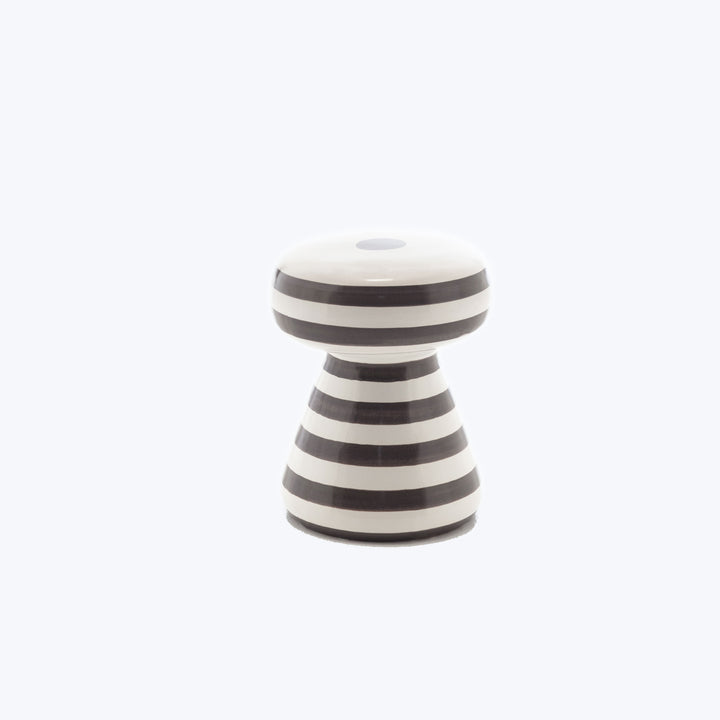 High-gloss black and white striped ceramic decorative object on white background