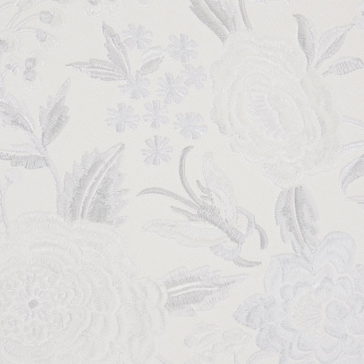 Intricate floral lace pattern on delicate white fabric, elegant and sophisticated.